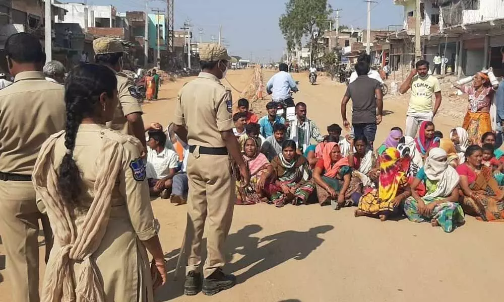 Podu farmers staging a protest on the road near bus station centre in Gudur on Tuesday