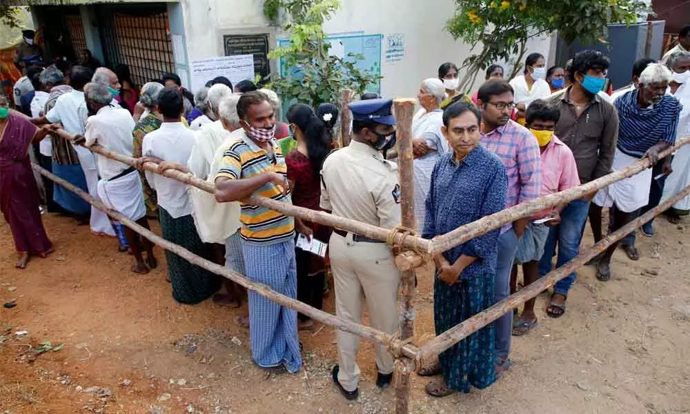 Voters in a queue line at a polling station at Kammapalli village in Ramachandrapuram mandal in Chittoor district on Tuesday