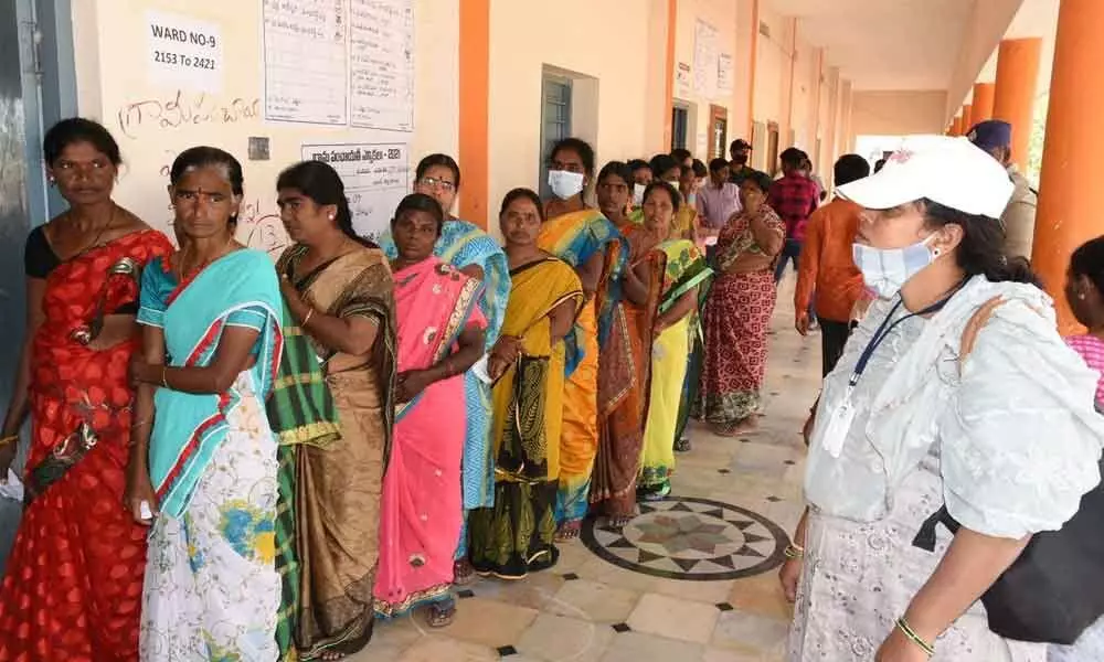 Voters waiting in queue line at a polling centre at Patnam village in Kadiri revenue division in the first phase panchayat elections in Anantapur district on Friday