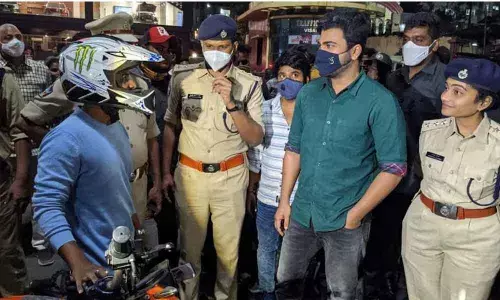 Actor Sharwanand imparting a traffic lesson to a commuter on the Beach Road in Visakhapatnam on Tuesday