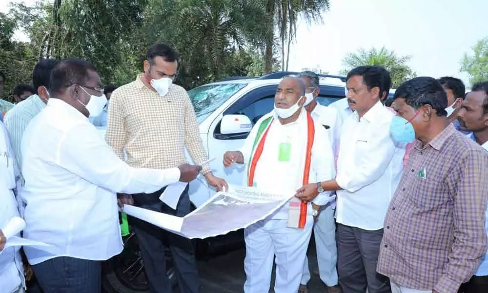 District Collector RV Karnan and MLA Sandra Venkata Veeraiah checking the map of land in Sathupalli on Wednesday
