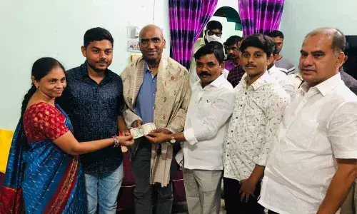 AIUEC Vice-President Dr Pulla Srinivas, Chief Whip D VInay Bhaskar and others handing over Rs 50,000 donation to TSWREIS Secretary RS Praveen Kumar for ‘payback to society’ foundation in Warangal on Thursday