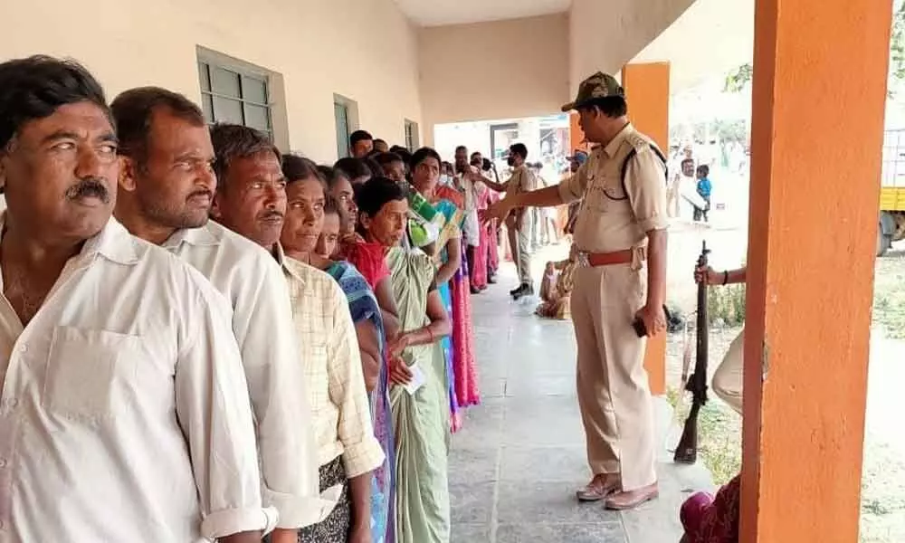 A large number of voters stand in queue at a polling booth in Kalyandurgam in Anantapur on Saturday to exercise their franchise in GP polls