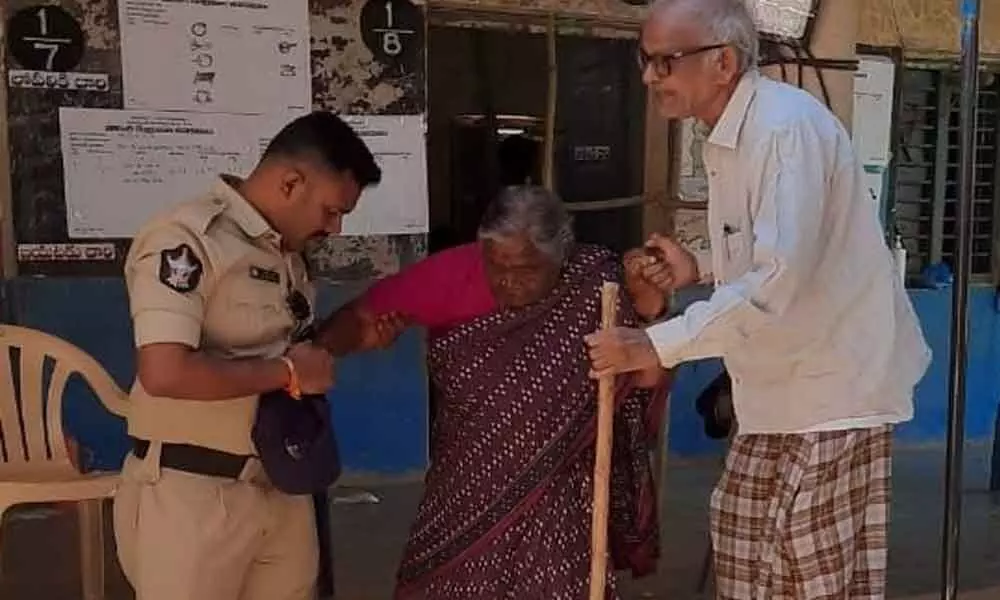Police helping an elderly couple to exercise their franchise at polling booth in Bugganapalle panchayath of CK Dinne mandal on Saturday