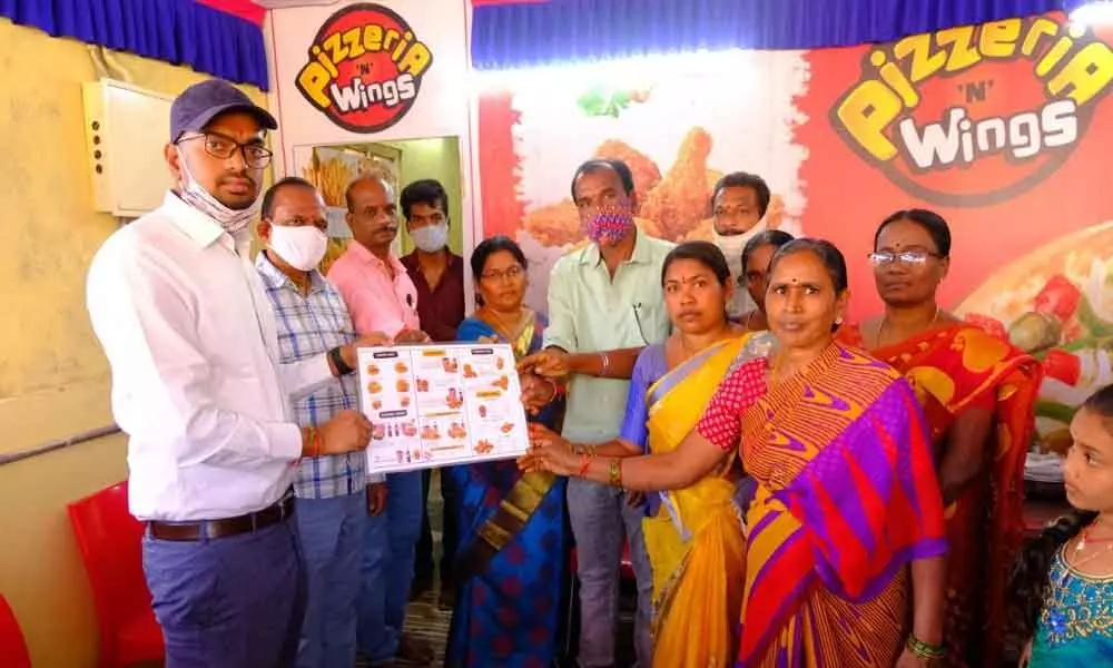 Additional Collector Adarsh Surabhi with the Mahila group (SHG) at the inauguration of Pizza Centre in Mulugu on Saturday