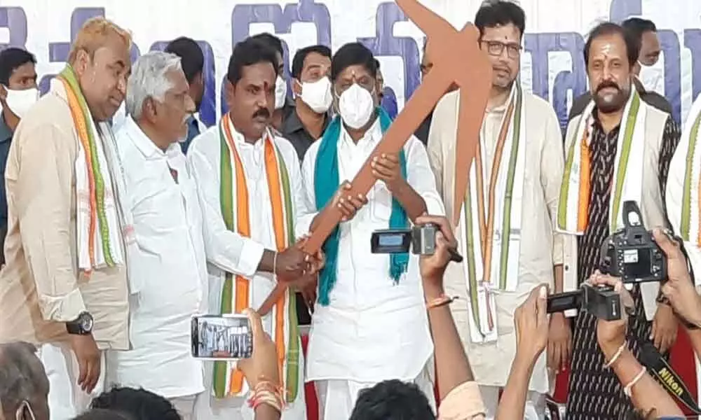Congress Legislature Party leader Mallu Bhatti Vikramarka holding a plough during a meeting with farmers in Karimnagar on Saturday