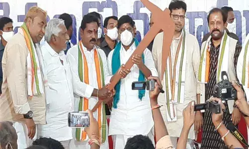 Congress Legislature Party leader Mallu Bhatti Vikramarka holding a plough during a meeting with farmers in Karimnagar on Saturday