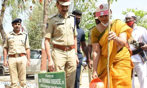 OSD in Chief Minister’s Office Priyanka Varghese watering a sapling after planting it on the premises of city police training centre in Karimnagar on Saturday. Police Commissioner VB Kamalasan Reddy seen next to her