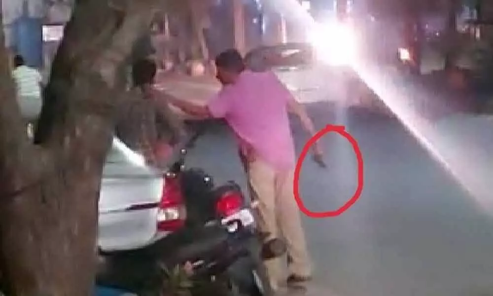 Head constable moving with a gun near MGM Hospital in Warangal on Saturday night