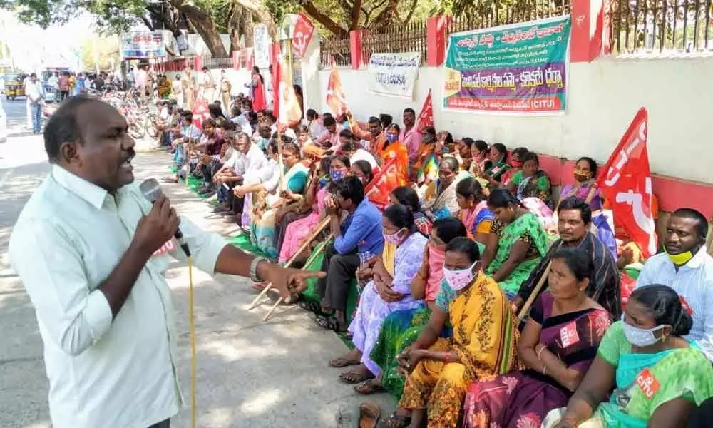 CITU district secretary Ch Srinivasa Rao addressing at the protest by the municipal workers in Ongole on Monday