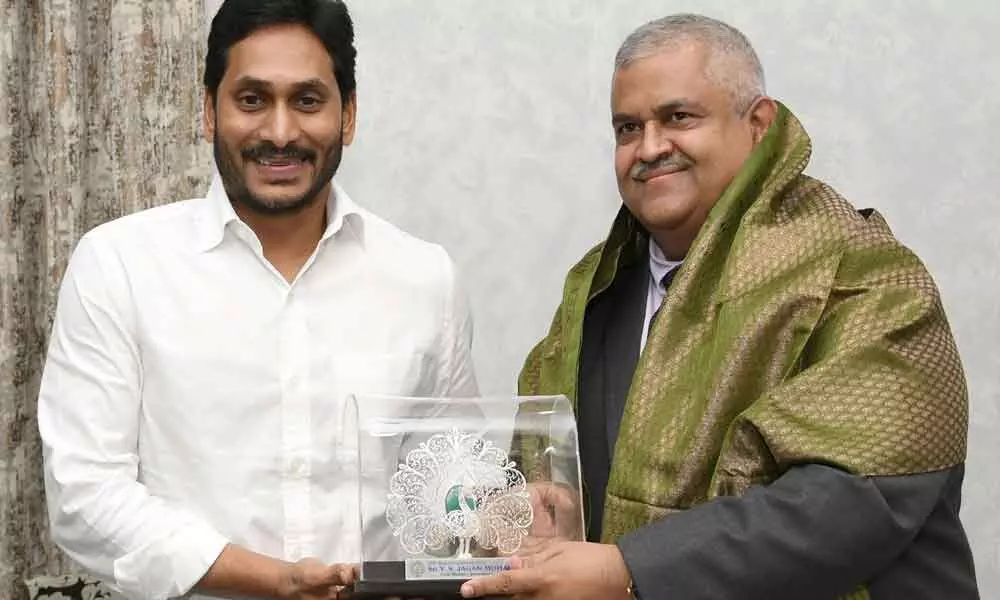 Chief Minister Y S Jagan Mohan Reddy at his camp office in Tadepalli on Monday felicitating United Nations Assistant Secretary General Satya S Tripathi
