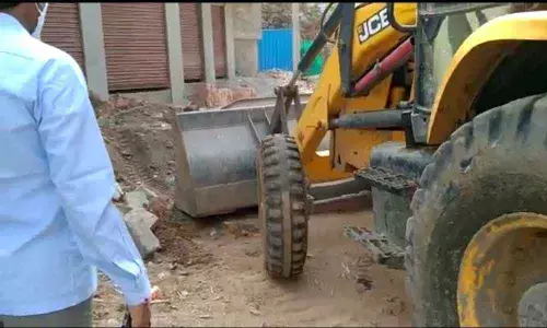 Municipal officials demolishing the steps of a shopping complex in Kodad  town on Monday