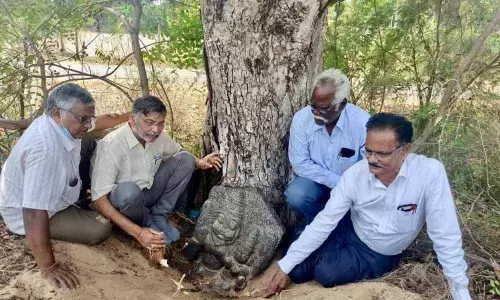 Emani Sivanagireddy and Jyothi Chandramouli inspecting the Lakshmi Narasimha idol in Motupalli village on Tuesday