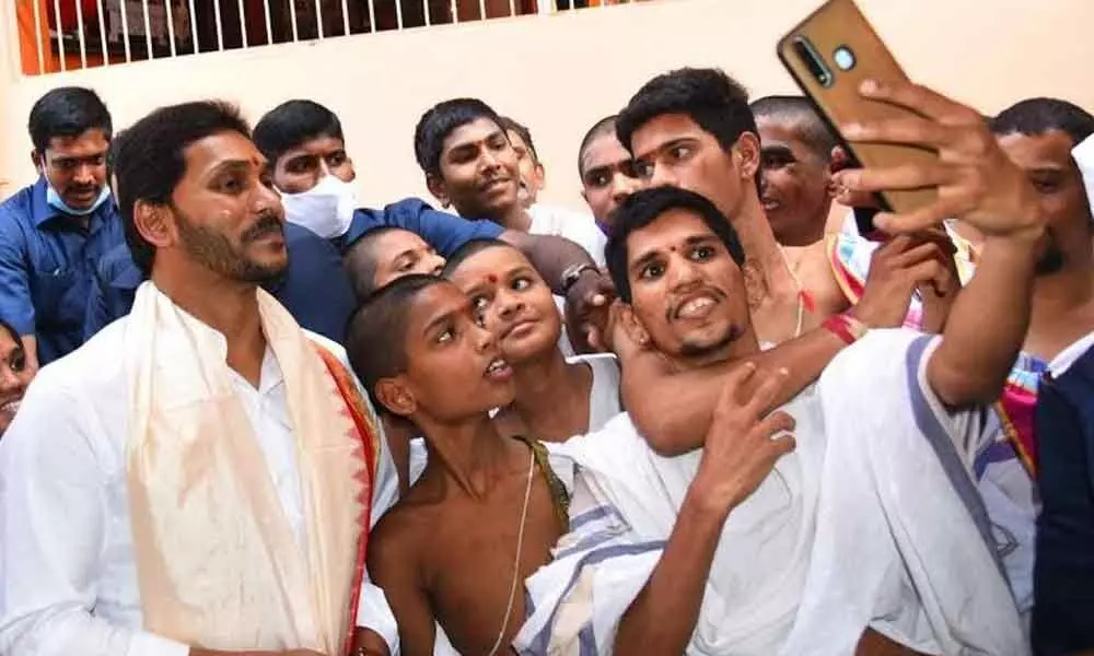 Vedic students pose for a selfie with Chief Minister YS Jagan Mohan Reddy who participated in Varshika Mahotsavam at Visakha Sri Sarada Peetham in Visakhapatnam