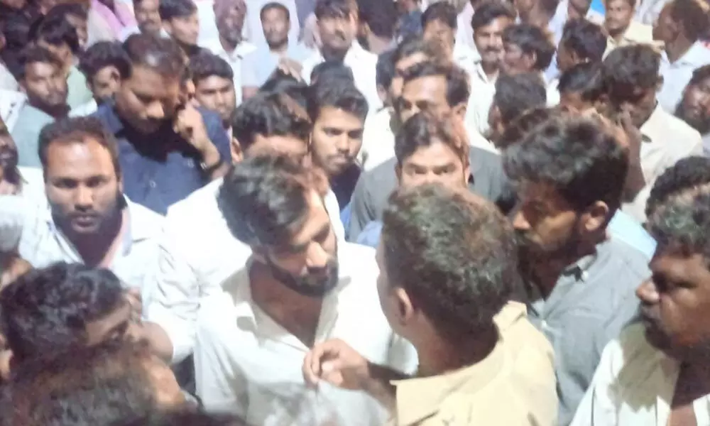 YSRCP Nandikotkur in-charge B Siddartha Reddy argues with police personnel at Prathakota polling centre late on Wednesday night