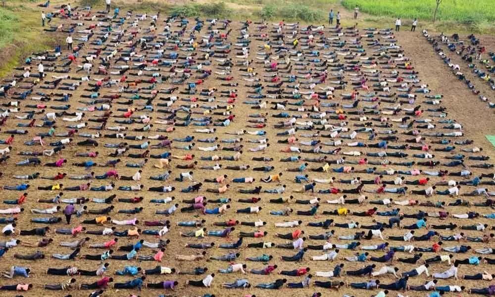 People performing Surya Namaskara in the programme organised by JCI in Ongole on Friday