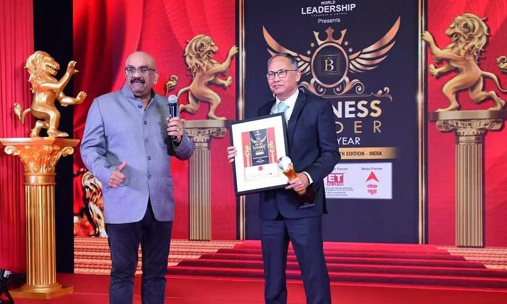 The Business leader of the Year for CSR Initiatives (Social Development) Award being received by Sumit Deb (right), the CMD, NMDC