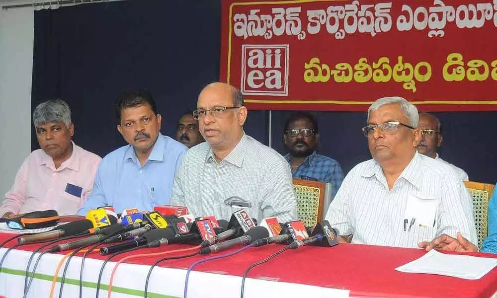 South Central Zone Insurance Employees Federation president K Venugopal Rao and members addressing a press conference in Vijayawada on Friday
