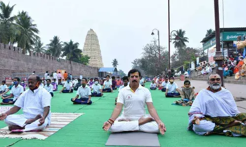 Temple EO K S Rama Rao, officials and staff taking part in Surya Aradhana on the occasion of Rathasaptami at Srisailam on Friday
