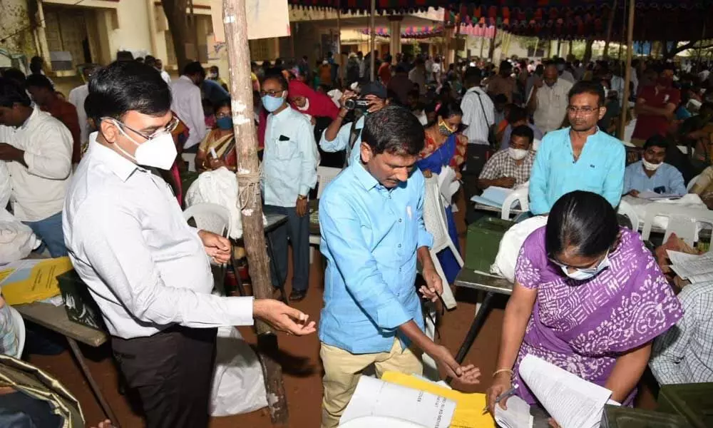 Collector K V N Chakradhar Babu observing the election material at the Kovur distribution centre in Nellore on Saturday