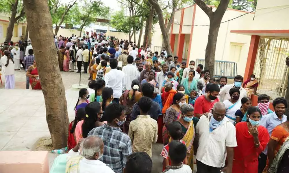 People waiting in a queue line at a polling station at Tiruchanoor in Chandragiri Assembly constituency in Chittoor