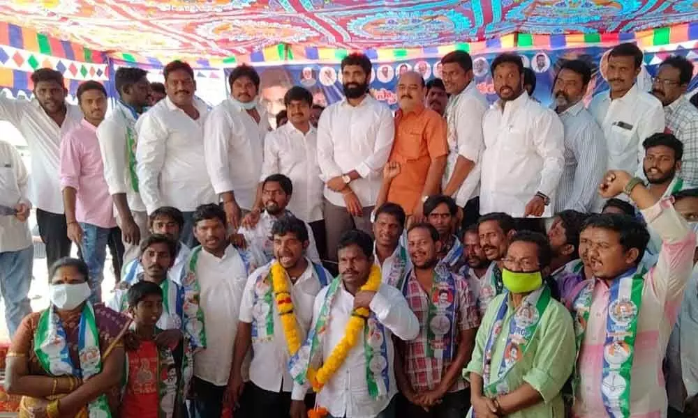 MP Bharat and YSRCP rural coordinator Chanadana Ramesh with newly joined members at Dowleswaram on Sunday