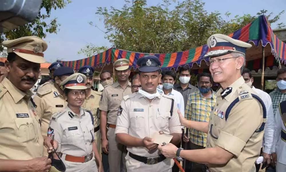 DGP D Gautam Sawang presenting cash award to a constable at Kothavalasa in Vizianagaram