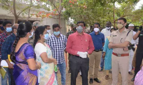 District Collector J Nivas and SP Amith Bardhar interacting with officers at a polling station in Etcherla mandal
