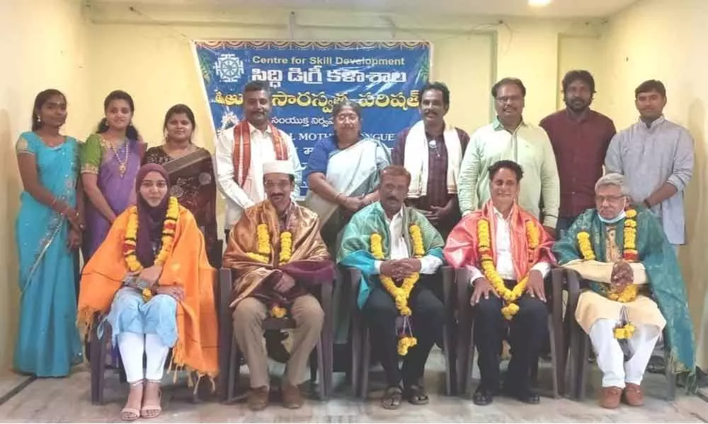 Saraswatha Sabha felicitating the guests to mark International Mother Tongue Day in Rajamahendrvaram on Monday.  YSRCP leader J Vijaya Lakshmi and Dr PVB Sanjeev Rao seen (standing).