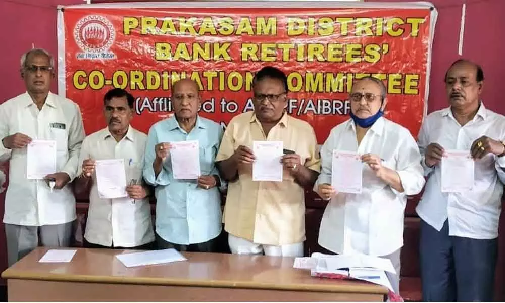 Bank Retirees Federation leaders releasing a pamphlet about the first district level meeting in Ongole on Monday