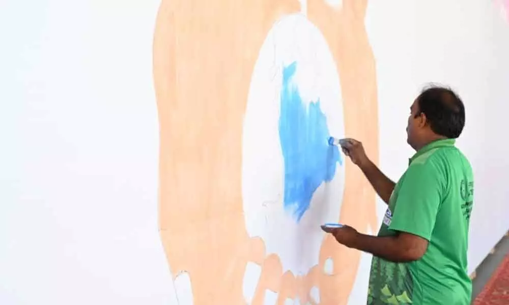 Artist Ameerjan starts painting for Guinness World Record at Rainbow School in Nellore on Monday