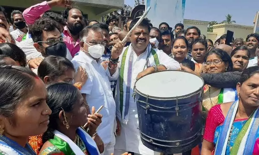 Tourism Minister M Srinivasa Rao playing drums to cheer the winning candidates and party activists at Bheemunipatnam constituency party office on Monday.