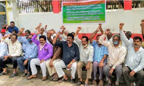 Ongole Dairy employees protesting in front of the Collectorate in Ongole on Monday