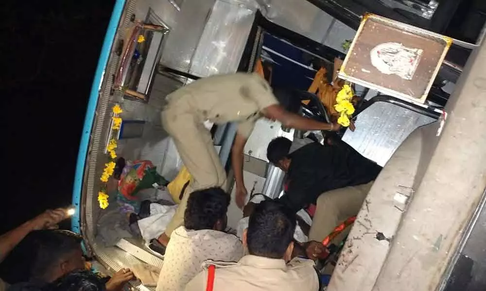 Police personnel bringingout the injured passengers from the tilted bus