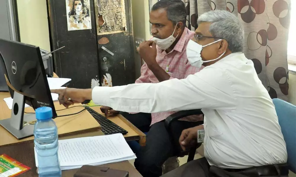 An ACB official inspecting computer records during searches at Durga temple recently