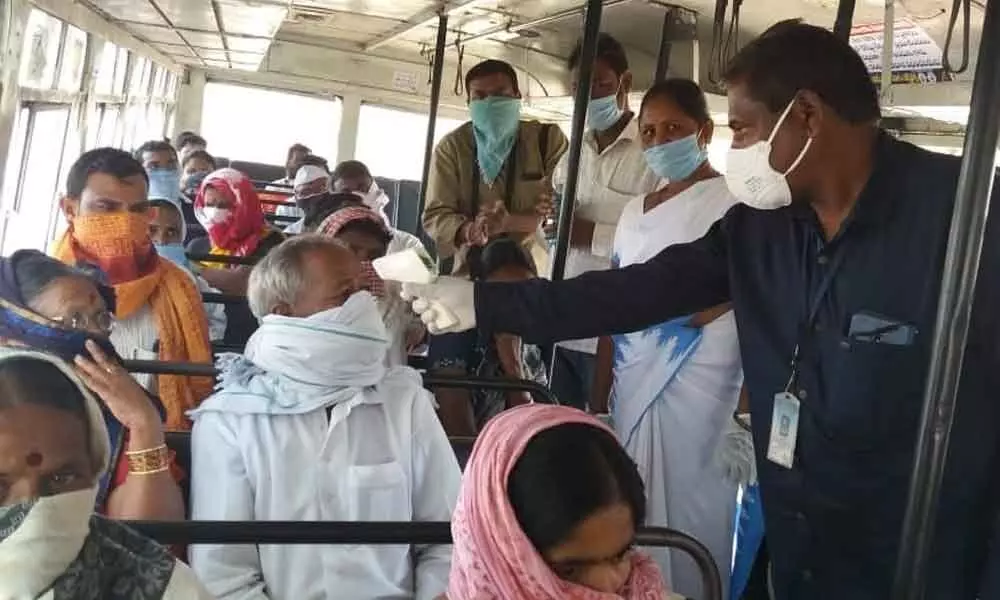 Officials conducting Covid test to the passengers in a bus coming from Maharashtra at Salabatpur RTA check post on Wednesday