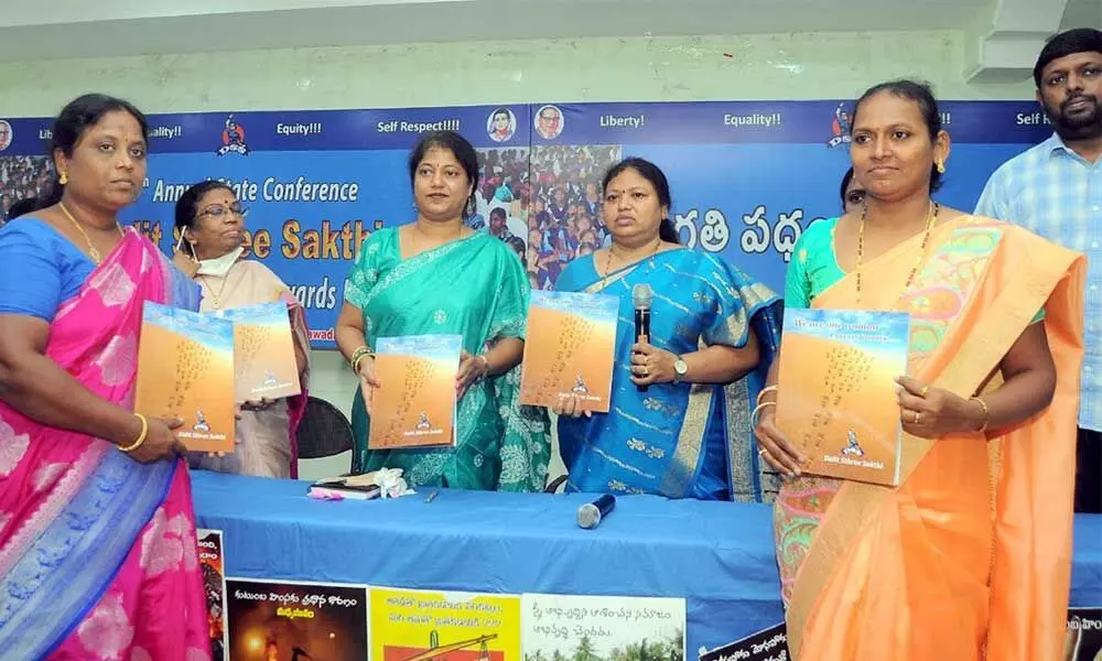 Principal Secretary of Social Welfare Department Kaki Sunita releasing souvenir at the 15th annual conference of Dalit Sthree Sakthi in Vijayawada on Wednesday
