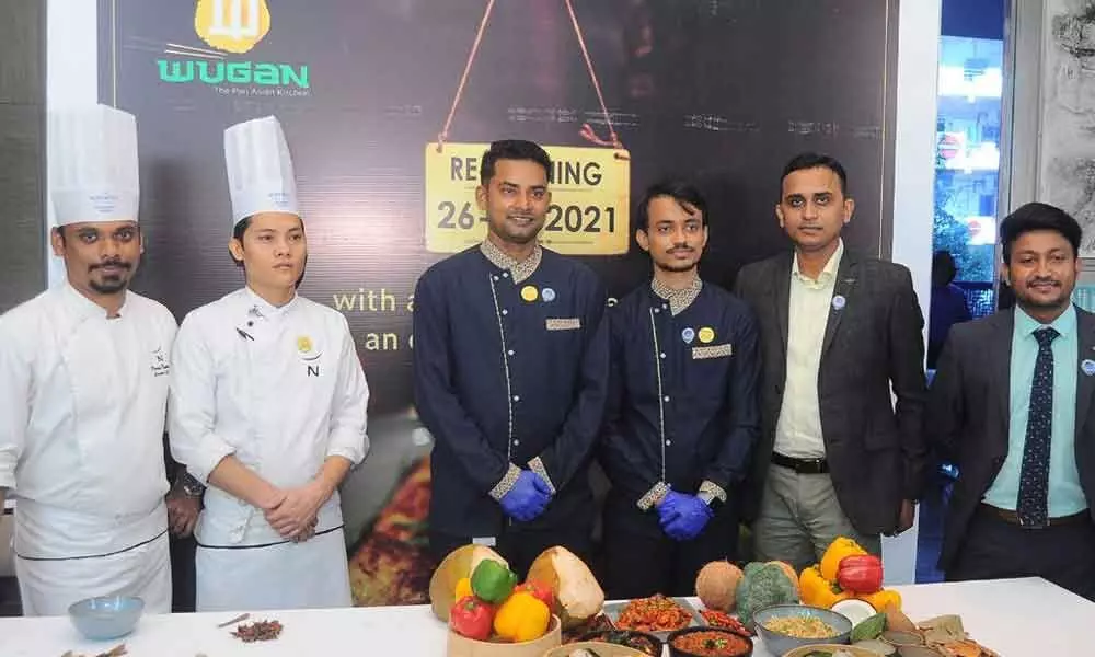 Operations Manager Abhishek Pani and chef Vijay Kumar displaying delicacies as part of re-opening of Wugan, at Novotel in Vijayawada on Friday