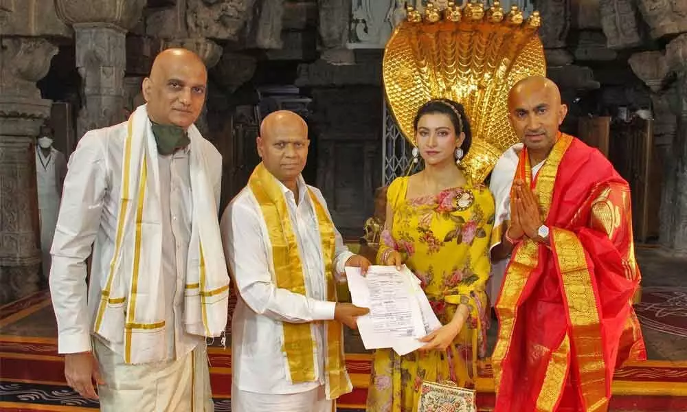 PASCO company CEO Sanjay Passi and his wife Shalini handing over demand draft for Rs 10 crore to Addl EO of TTD at Tirumala temple on Friday