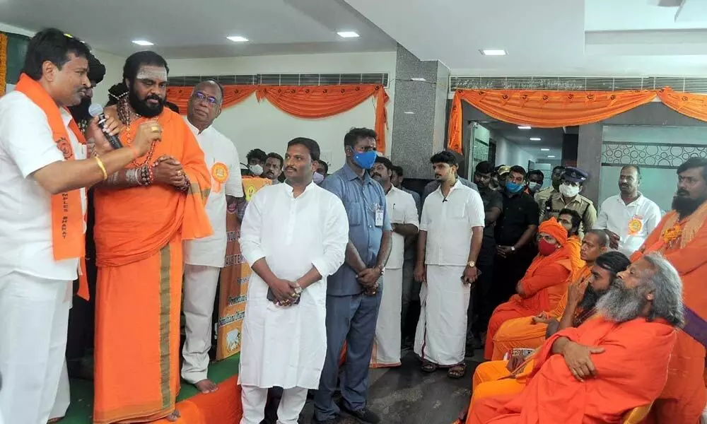 Minister for Endowments Velampalli Srinivas greeting Swamijis at a symposium on Sanathana Dharma in Vijayawada on Sunday