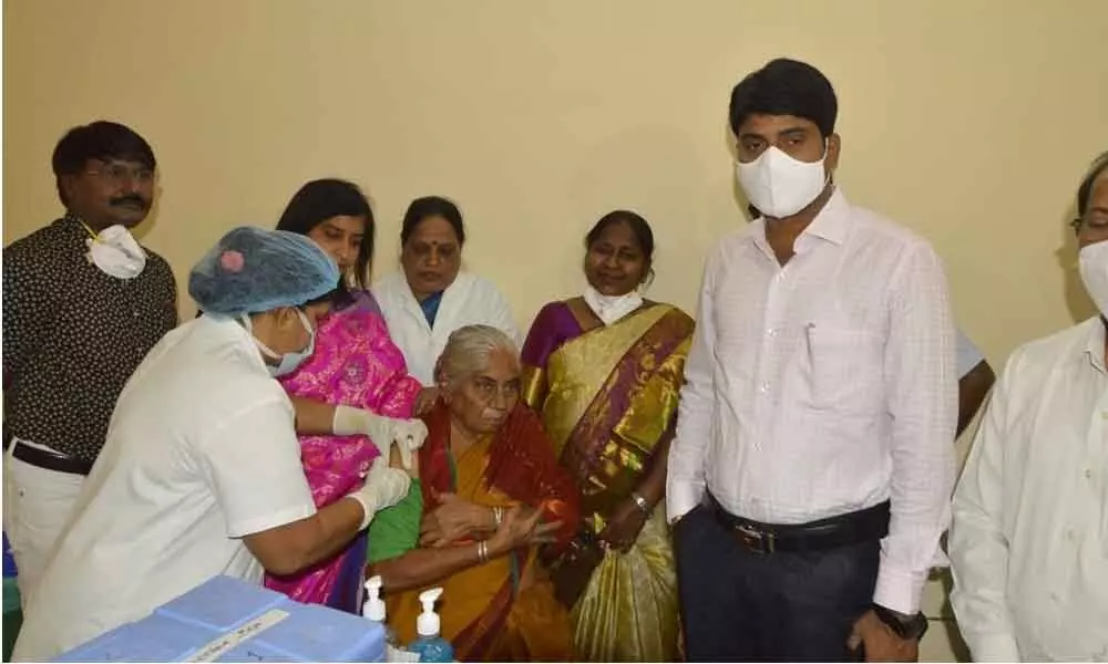 District Collector C Narayana Reddy’s mother taking the first Covid-19 vaccine at Government Hospital in Nizamabad on Monday