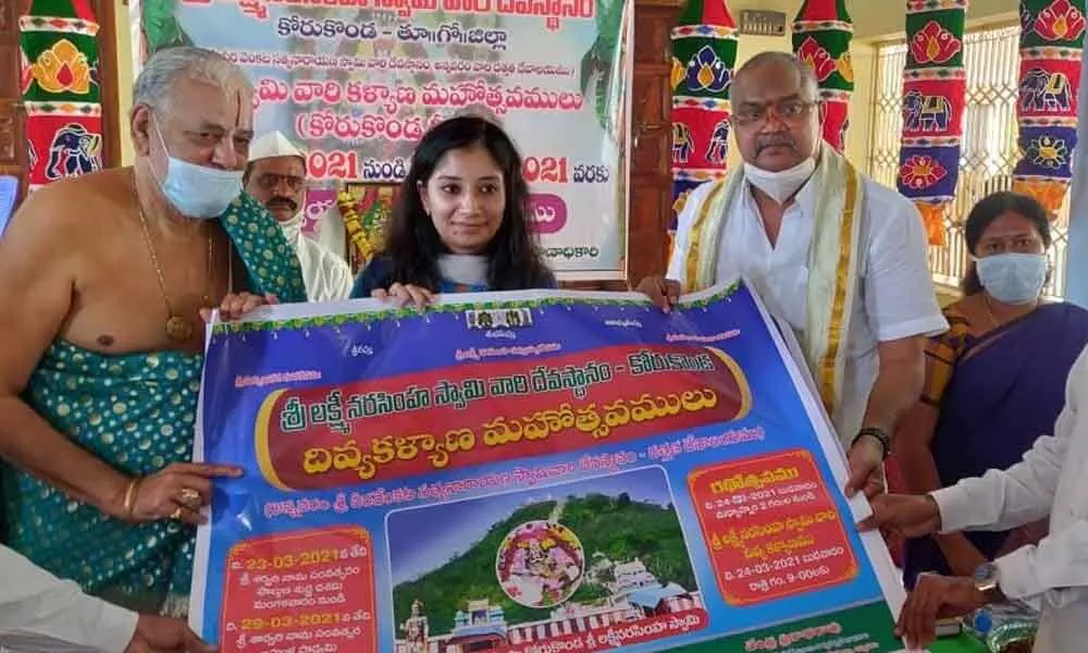Sub-Collector Anupama Anjali releasing poster on Lakshmi Narasimha Swamy Kalyanotsavam in Korukonda on Thursday