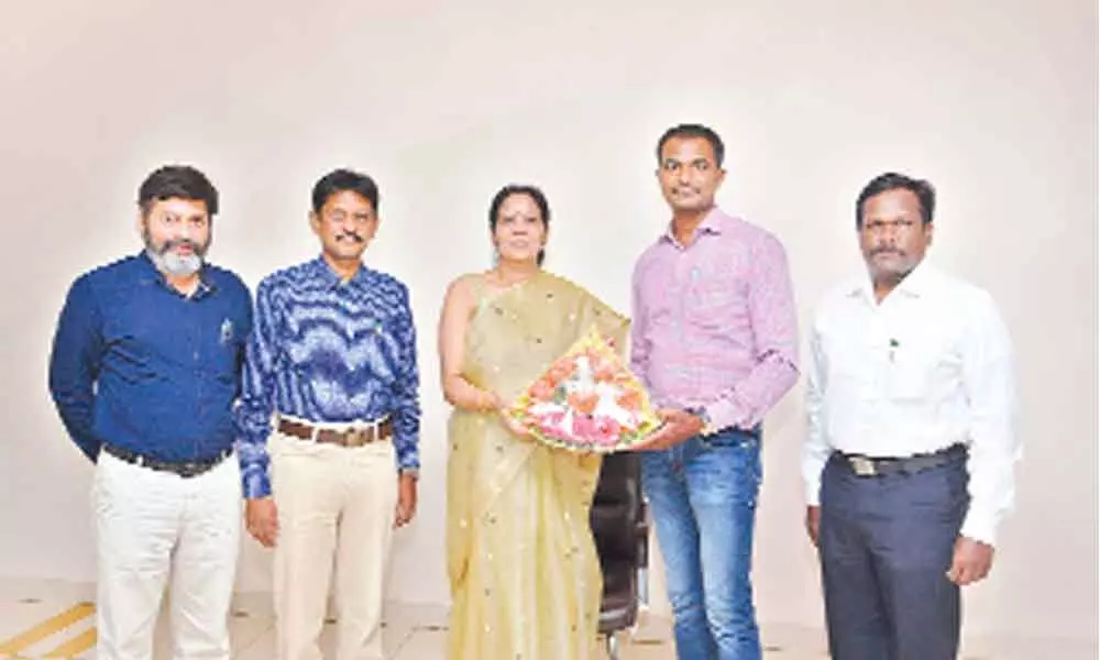 Palamuru University authorities and staff congratulating Dr A Shiva Kumar for getting first Ph D from the varsity, in Mahbubnagar