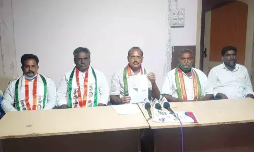 Prakasam DCC president Eda Sudhakar Reddy showing copies of documents submitted by the candidates in Ongole on Thursday