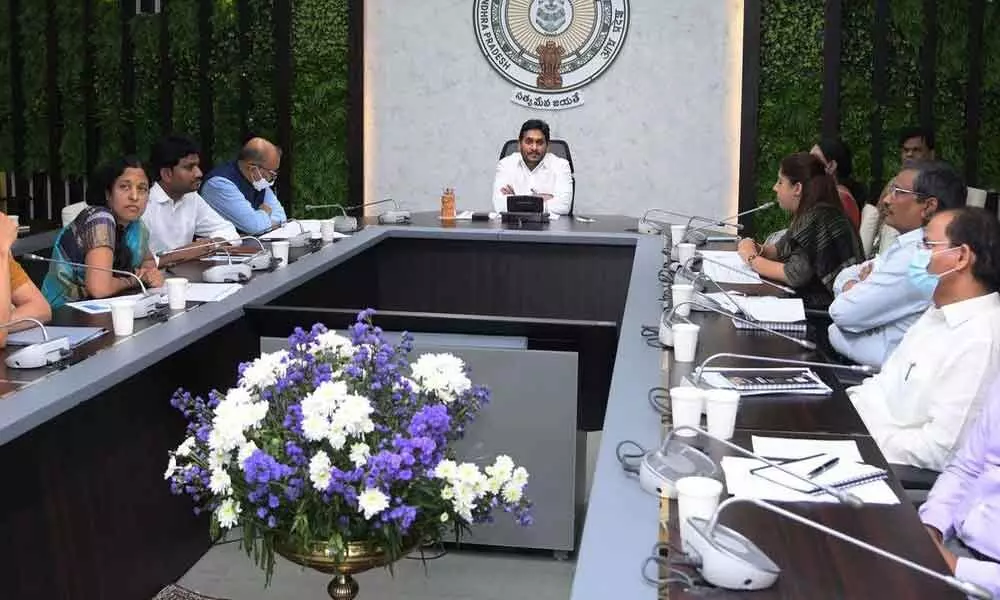 Chief Minister Y S Jagan Mohan Reddy reviews plans for distribution of sanitary napkins for schoolgirls at his camp office on Friday