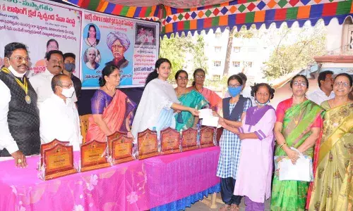 MLA Adireddy Bhavani distributing scholarships at Walkers Club in Rajamahendravaram on Friday