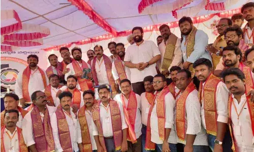 Rajanagaram MLA Jakkampudi Raja felicitating Photographers’ Association members in Korukonda on Friday
