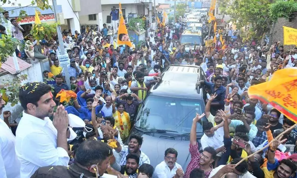 TDP national  general secretary  Nara Lokesh greeting  people  during  a road show  in Ongole  on Saturday