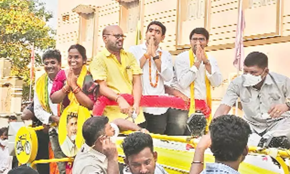 TDP leader Nara Lokesh waving at crowds during election campaign