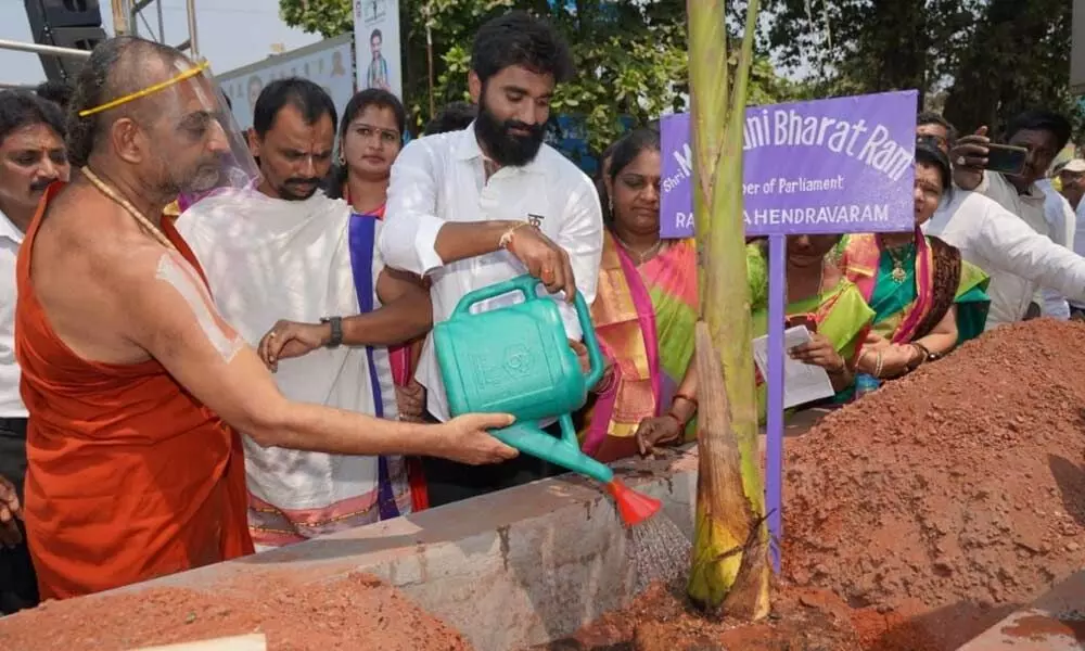 Tridandi Srimannarayana Ramannuja Jeeyar Swamy watering plant along with MP Bharat at Lala Chervu centre on Monday